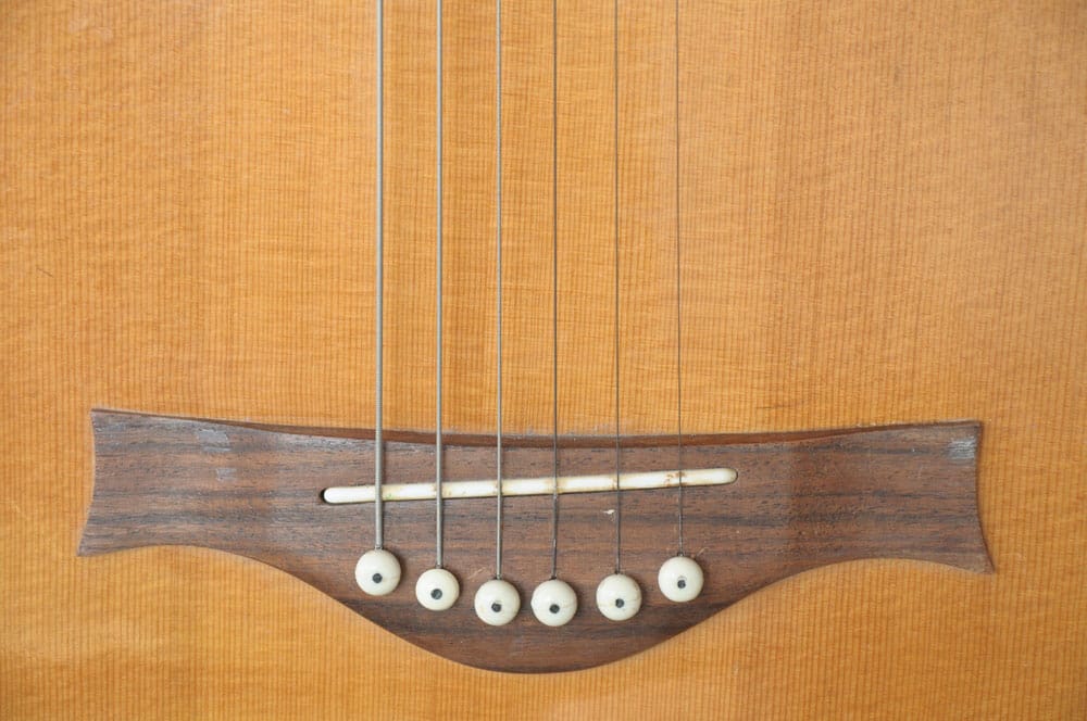 Guitar bridge and saddle close up